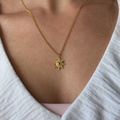 Gold sun charm necklace on 18k gold-plated chain with minimalist coastal design