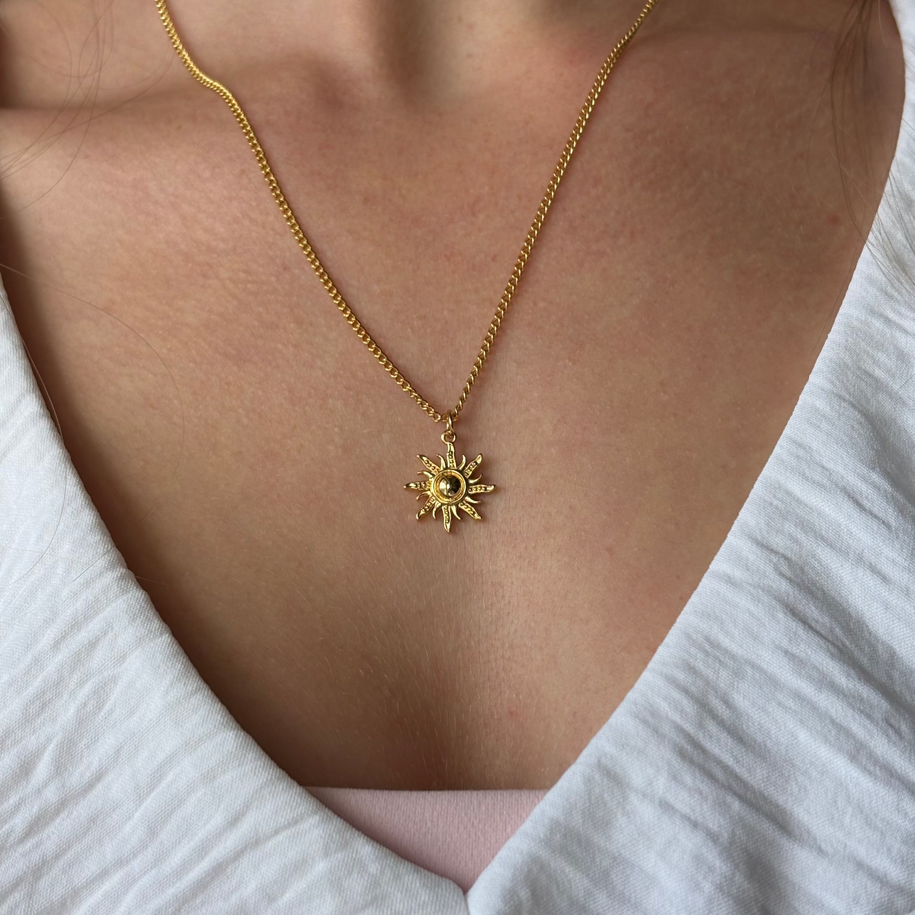 Gold sun charm necklace on 18k gold-plated chain with minimalist coastal design